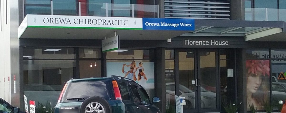 The front of Florence House on Florence Avenue, with the blue Orewa Massage Worx sign on the awning beside the Orewa Chiropractic sign